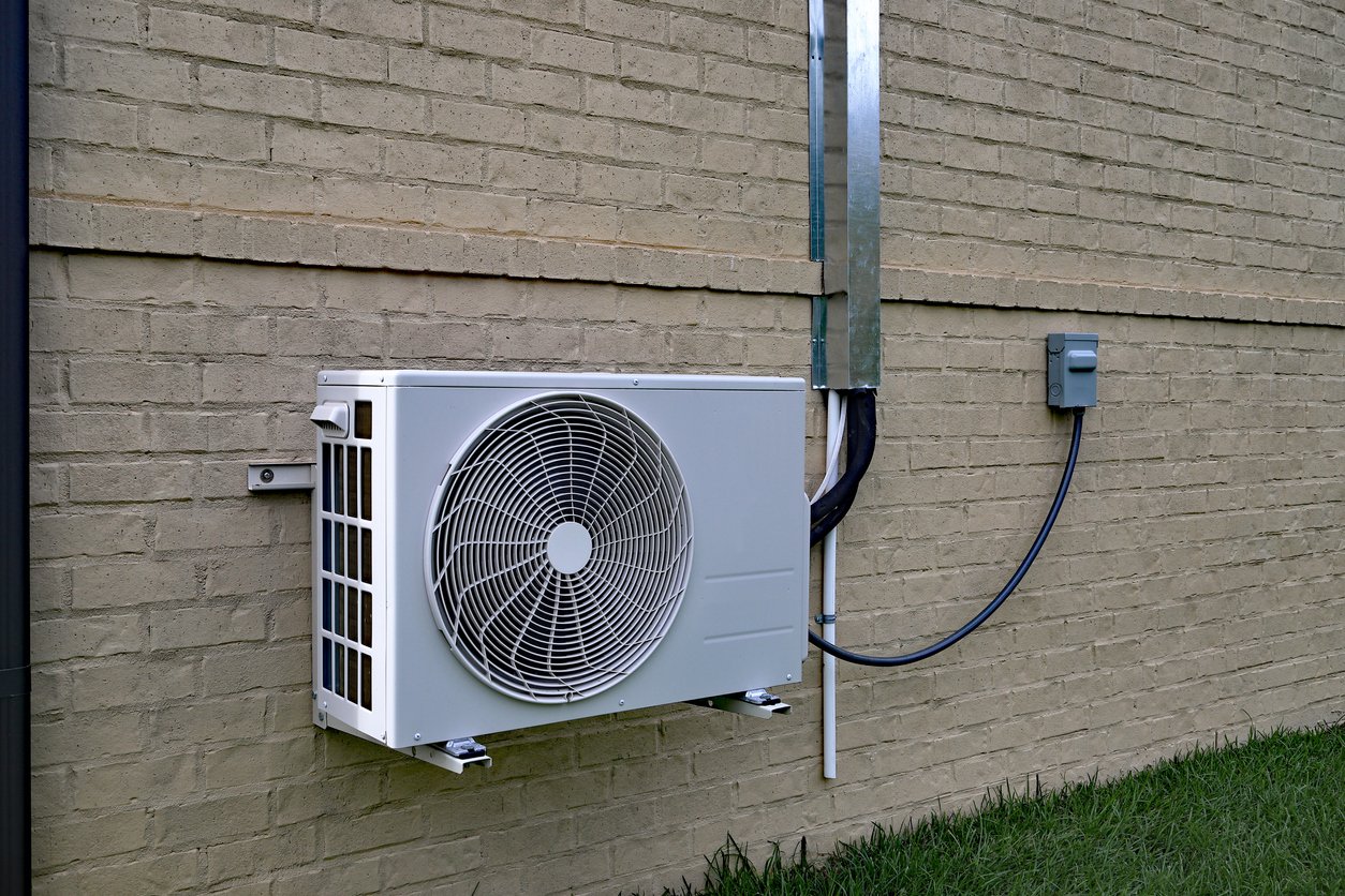 Technician installing a new air conditioning unit in a Southern California home