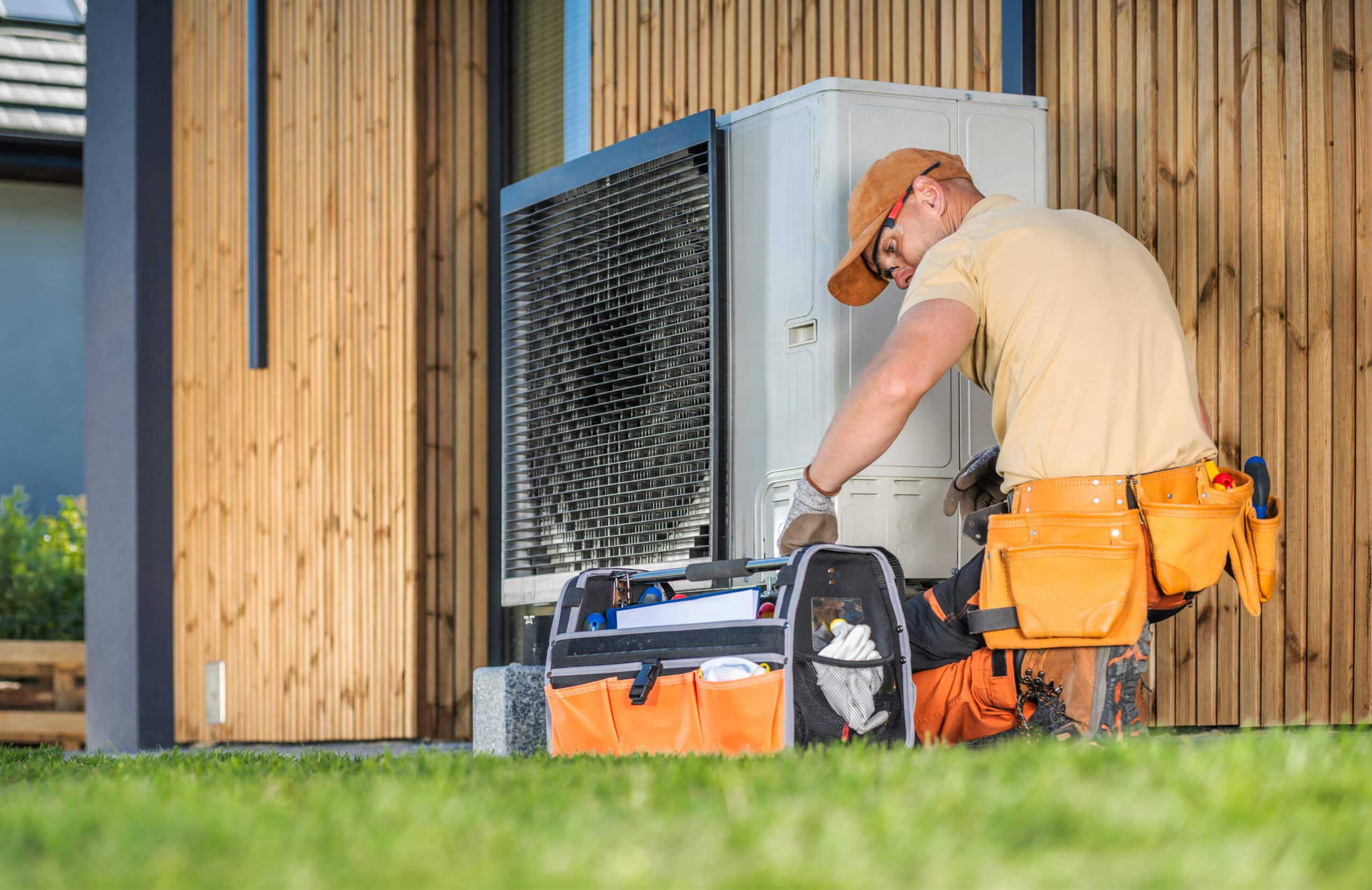 Technician performing fall heat pump service in Orange County home